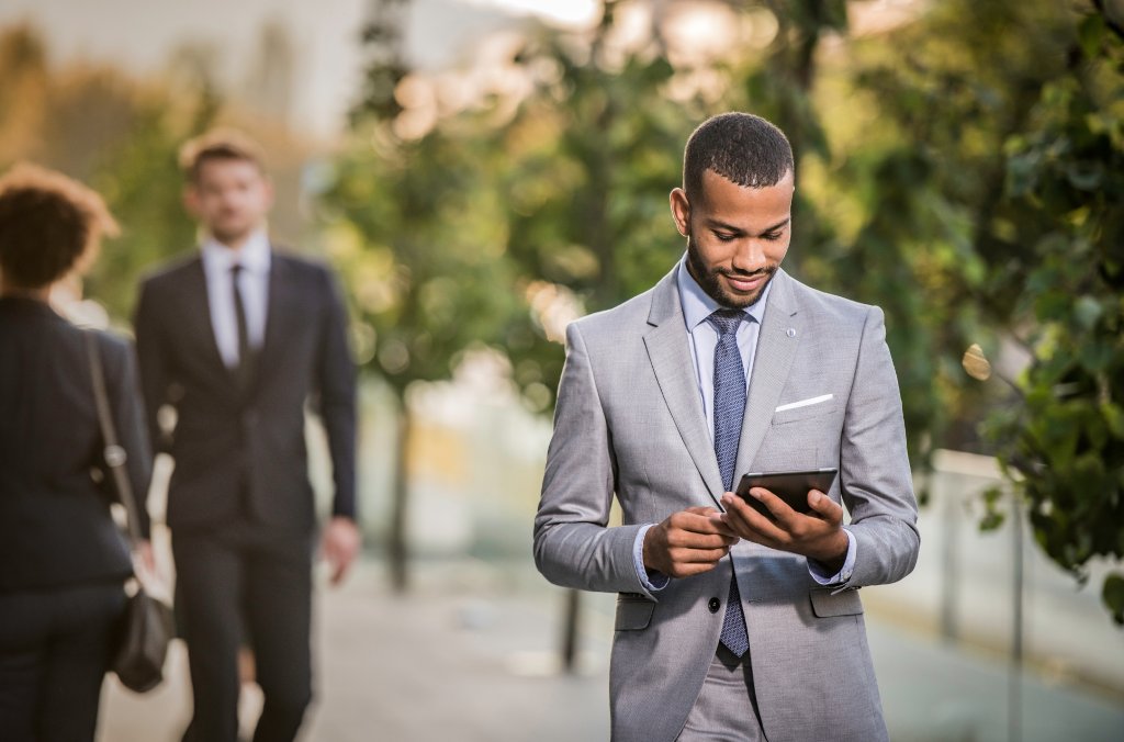 A man reading a security advisory on his tablet